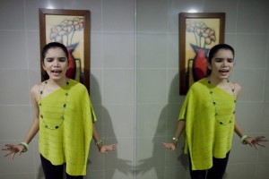 Thara Marie Santiago, a girl with autism, rehearses inside a washroom in Quezon City