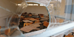 Chairs are seen through a broken window at the Garissa University College in Garissa