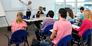 adults sit in training session with instructor