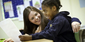 teacher works with boy with disability