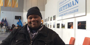 African American man sits in college building