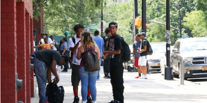 Teenagers standing outside of a school building