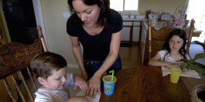 Deanna Ballard helps her son Zachary, who has autism, while his sister, Makenna, looks on. New research suggests that parent-led intervention can make a big difference for children with the developmental disorder. (Renee C. Byer/The Sacramento Bee/TNS)