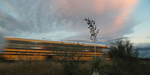 Blurry bus driving in rural area at dusk