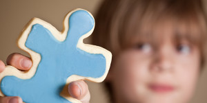 Autistic child holding blue puzzle piece