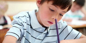 student writing at desk