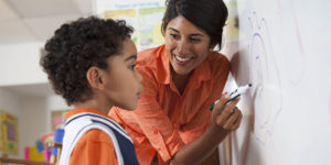 Teacher and student at whiteboard