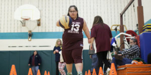 Rachel, with Down syndrome, playing basketball