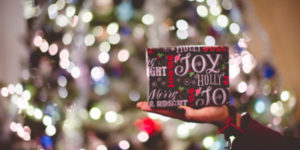 Gift in front of a blurry Christmas tree