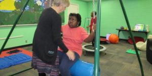 child on a swing in a classroom