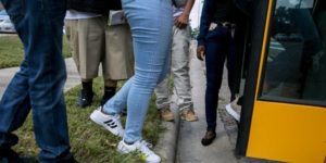 legs of students boarding a bus