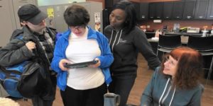 group of students looking at a tablet