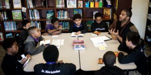 group of fifth graders at a book club with teacher