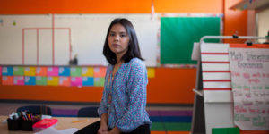 hispanic or latina young teacher in classroom daca