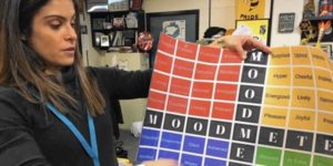 teacher holding up a mood meter