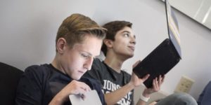 two male students on laptops