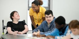 smiling teacher with students