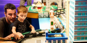 son with dad playing toys