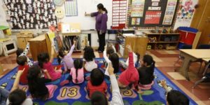 female teacher with group of young children