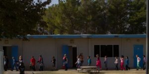 students walking outside of a school