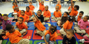 group of preK students wearing orange shirts except for one