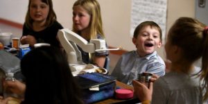 child with obi feeding robot