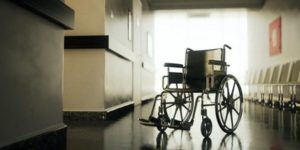 empty wheelchair in empty hallway