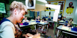 white teacher teaching a small group of children