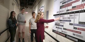 student pointing to poster