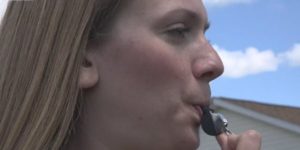 woman blowing whistle